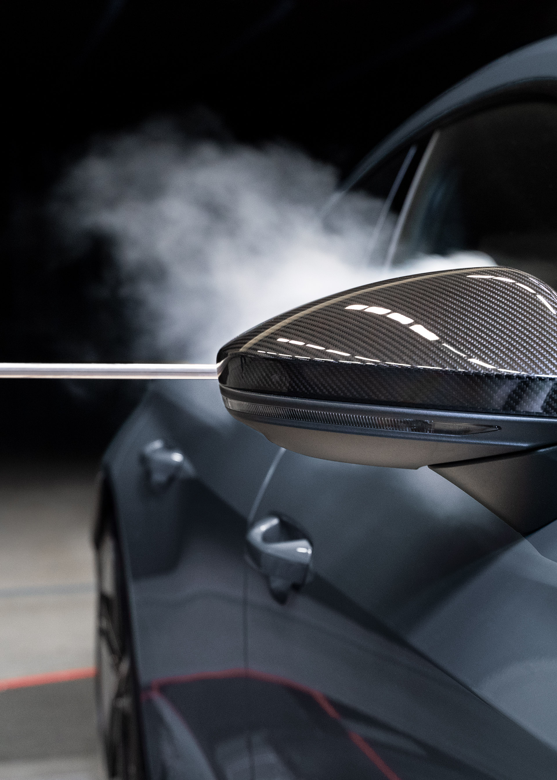 De rook laat zien hoe de luchtstroom zich gedraagt na het passeren van de buitenspiegel van de Audi RS e-tron GT.